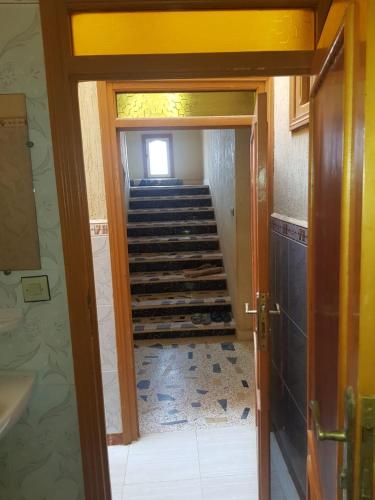 a hallway with a staircase in a house at cap bouya in Aït Farts