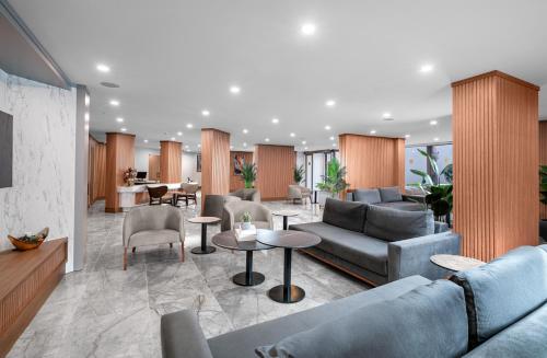 a living room with couches and tables and chairs at Sun Heaven Queen in Alanya