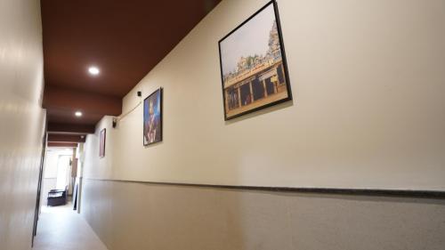 a hallway with paintings on the walls of a building at Anantha Shaiya in Tiruchchirāppalli