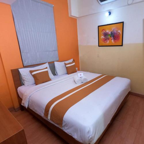 a bedroom with a large bed in a room at World Hotel Jakarta - Bandengan in Jakarta