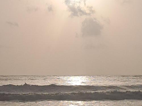 a person riding a wave in the ocean at Rks kashid beach villa in Kashid