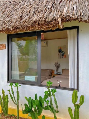 a room with a large window on the side of a house at Lacasa home&coffee Mộc Châu in Mộc Châu