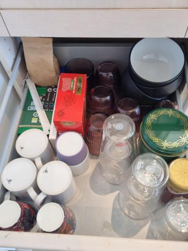 a drawer filled with lots of dishes and other items at Gæstehuset på Agerholm in Helsinge