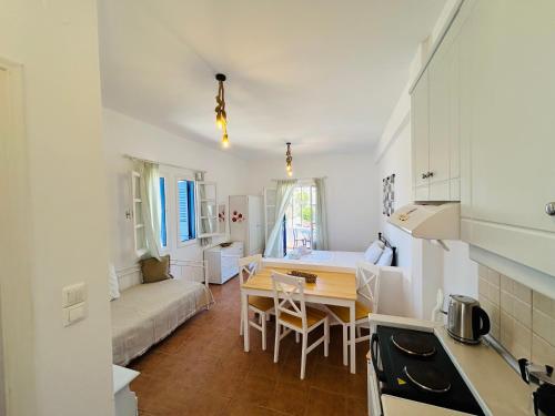 a kitchen and living room with a table and a couch at Hermes Apartments in Lipsoi