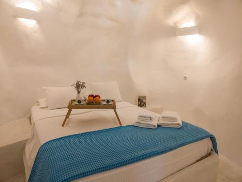 a small bedroom with a bed with a table on it at Maravites Cottage in Zefiría