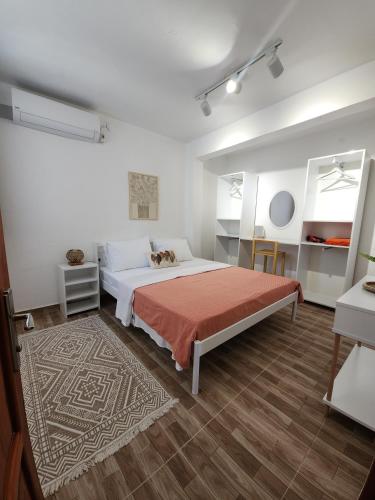 a bedroom with a large bed and a rug at Kavala Hotel Bodrum in Bodrum City