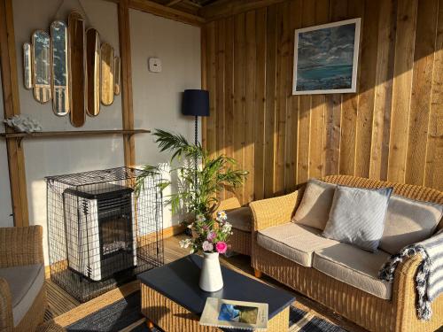 a living room with two couches and a fireplace at Tregantle Farm Eco GLAMPSITE in Torpoint