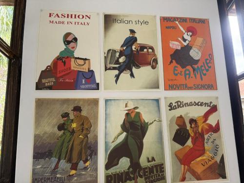 a bunch of posters hanging on a wall at LUCE SUL LAGO - CENTRO STORICO - Lake 3min walking in Bellano