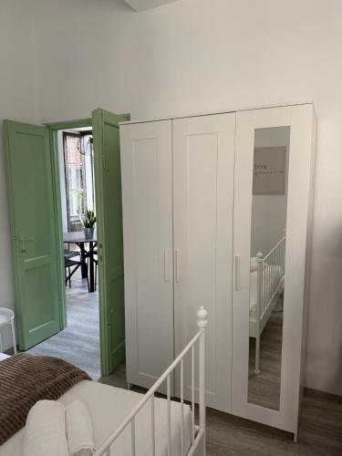a bedroom with a white cabinet and a staircase at LUCE SUL LAGO - CENTRO STORICO - Lake 3min walking in Bellano