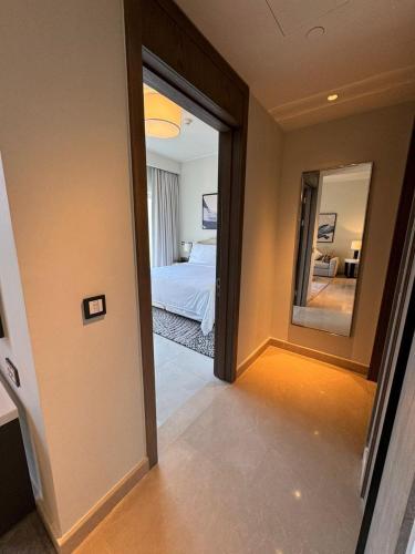a room with a bedroom with a mirror and a bed at Marassi luxury suites , the Address Resort , North coast in El Alamein