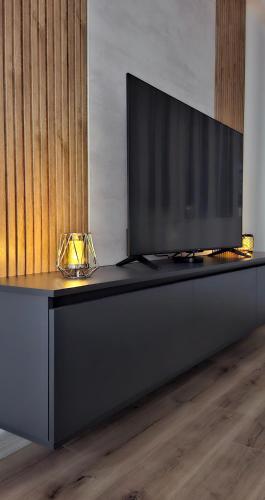 a black table with a television on top of it at Luxury condos on 18th, 5th and 3rd floor, with pool, fitness, parking included in Skopje