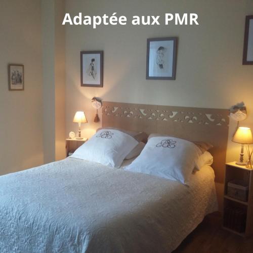 a bedroom with a white bed with two pillows at Du Coté de Lacoume in Anla