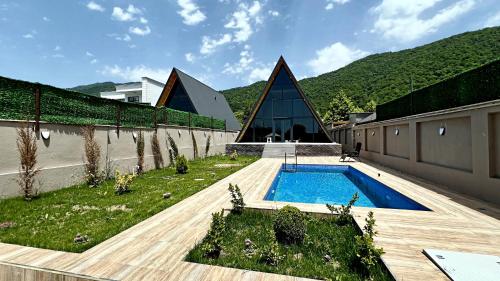 a house with a swimming pool in a yard at LuxFrame Gabala in Gabala