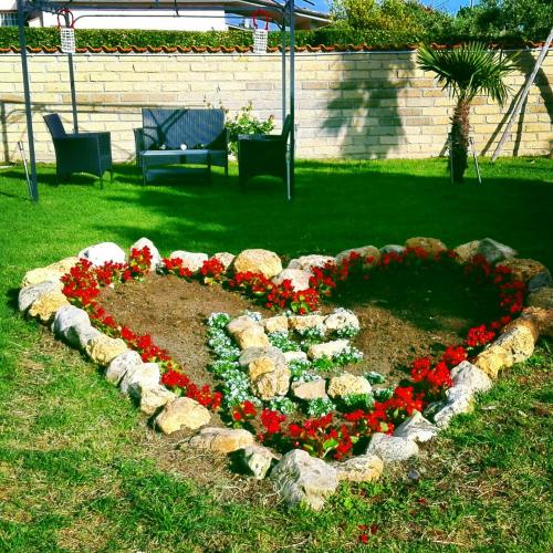 a circle of flowers in a garden at Elegance B&B in Ladispoli