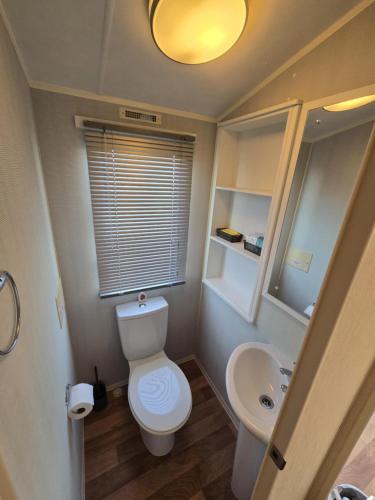a small bathroom with a toilet and a sink at Chasing The Dream k52, Ingoldmells, FREE WIFI in Ingoldmells