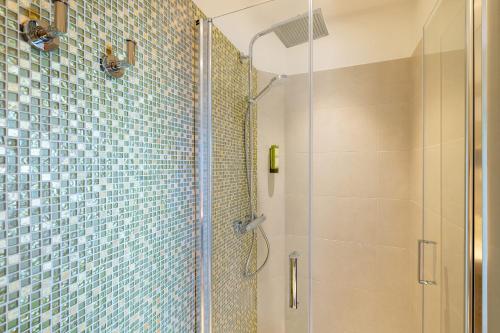 a bathroom with a shower with a glass door at Best Western Premier Montfleuri in Sainte-Maxime
