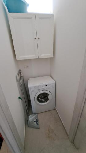 a small bathroom with a washing machine in a room at L' Amabile Volpe - Via Carlo Levi 2&2 in Pianoro
