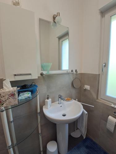 a bathroom with a sink and a mirror at Guesthouse Ostello dell Arte in Trarego Viggiona