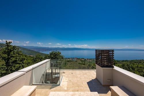 a balcony with a view of the water at Villa AltaVista - Seaview & Relax with Heated Pool & MiniGolf in Opatija