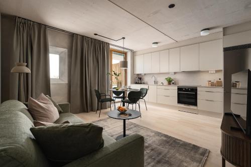 a living room with a couch and a table at Vander Aparthotel Inre Hamnen in Norrköping