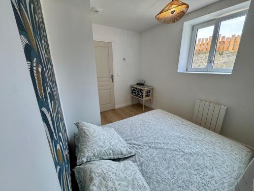 une chambre avec un lit et une fenêtre dans l'établissement Appartement cosy et rénové au cœur des vignes du Beaujolais, à Jullié