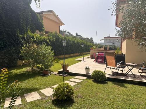 a backyard with a patio and a lawn at Fabiola home in Borgo Montenero
