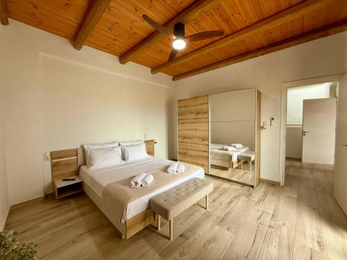 a bedroom with a bed and a ceiling fan at Aristea Seaside Retreat with Private Pool in Kalamaki Heraklion