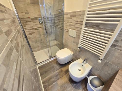 a bathroom with a toilet and a sink and a shower at Affittacamere Guest House Happy Holiday in La Spezia
