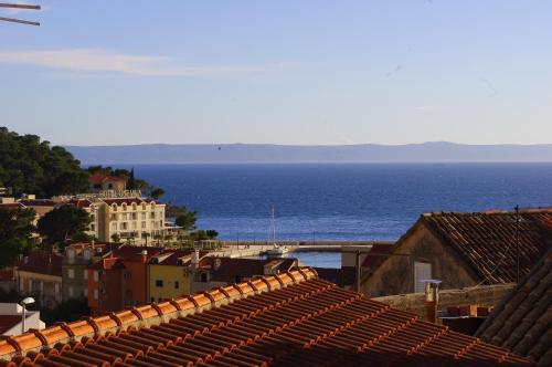 a view of a city with the ocean and buildings at Apartments Lux in Makarska