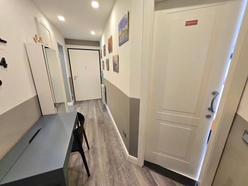 a hallway with a black bench and a door at Affittacamere Guest House Happy Holiday in La Spezia