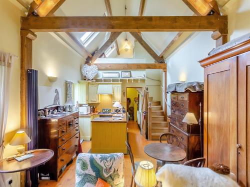 a kitchen with wooden ceilings and wooden tables at Little Tarbet in Dornoch