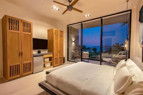 a bedroom with a bed and a view of the ocean at 3021 - La Montosa in Santa Cruz Huatulco