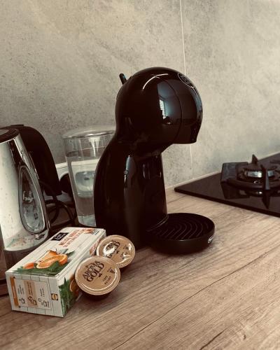 a hair dryer sitting on a table next to a box at M&M Apartment IV SELF CHECK-IN in Panevėžys