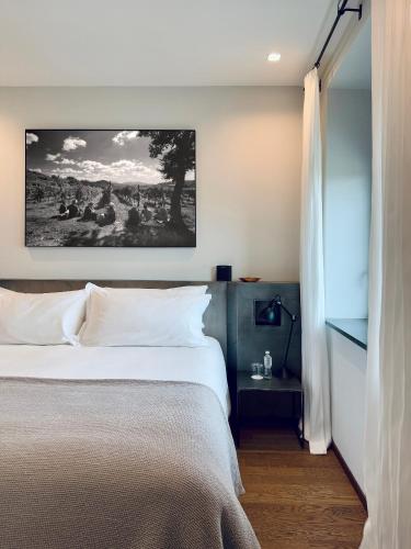 a bedroom with a bed and a painting on the wall at Borgo San Gregorio in Sorbo Serpico