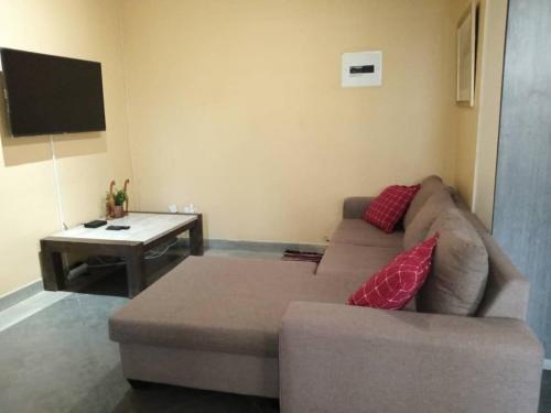 a living room with a couch and a table at Notwane court in Gaborone