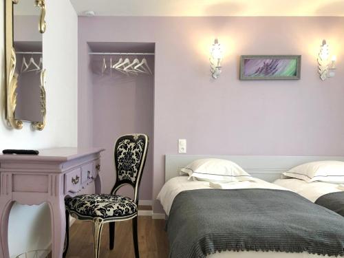 a bedroom with two beds and a desk and a chair at Hôtel D’Artiste in Pierrefontaine-les-Varans