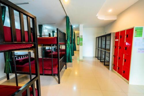 a row of bunk beds in a room with red lockers at Samui Backpacker Hotel in Bang Rak Beach