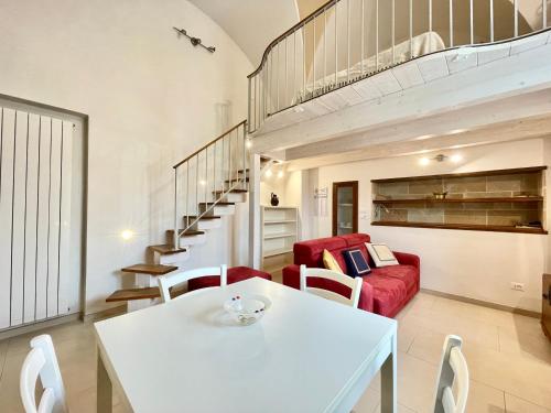 a living room with a white table and a red couch at Il Posticino di Tiggiano in Tiggiano