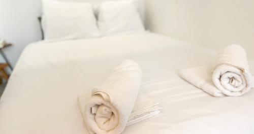un lit blanc avec des serviettes dessus dans l'établissement Hypercenter - Haven of peace near Corps Saints, à Avignon