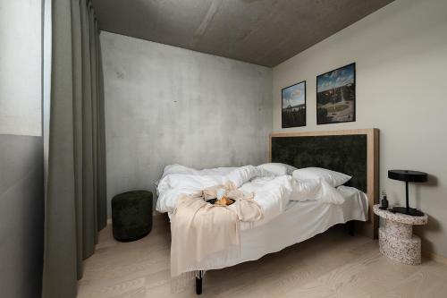 a bedroom with a bed with a stuffed animal on it at Vander Aparthotel Inre Hamnen in Norrköping