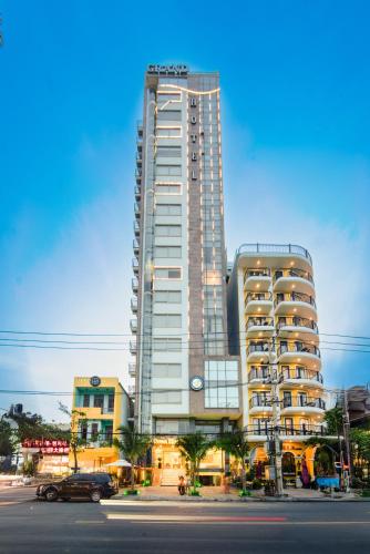 a tall building with a car parked in front of it at Ocean Bliss Hotel - Free Sauna in Da Nang