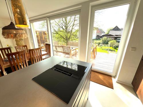 a kitchen with a table with a view of a porch at Haus am Fluss- nur 5 Minuten zum Europapark und direkt am Naturschutzgebiet in Kappel-Grafenhausen