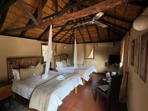 a bedroom with two beds in a room at Phokoje Bush Lodge in Selebi-Pikwe