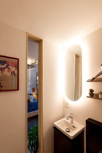 a bathroom with a sink and a mirror at Studio Silver - Central City - Free Parking in Basel