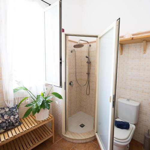 a shower stall in a bathroom with a toilet at Ciriga Sicily Glamping in Santa Maria Del Focallo
