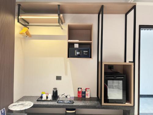 a small kitchen with a counter and a microwave at Zip By Spree Hotels Chinchwad in Chinchiwad