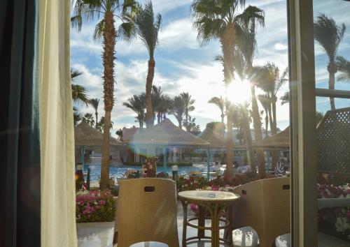 a view of a resort with palm trees and a pool at Sierra Sharm El Sheikh in Sharm El Sheikh