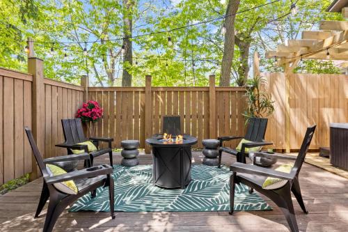 a patio with a table and chairs and a fence at Hot Tub! Close to Cornell, Ithaca College, Commons! in Ithaca