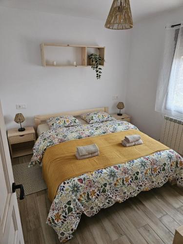 a bedroom with a bed with two pillows on it at Casa TioPito in Vadocondes