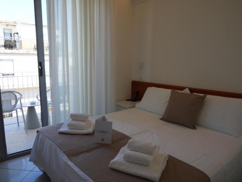 Postel nebo postele na pokoji v ubytování Hotel Regal